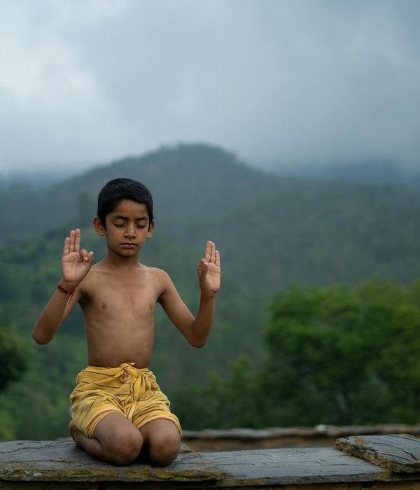 Woman peacefully practicing a breathing exercise in a calm environment.